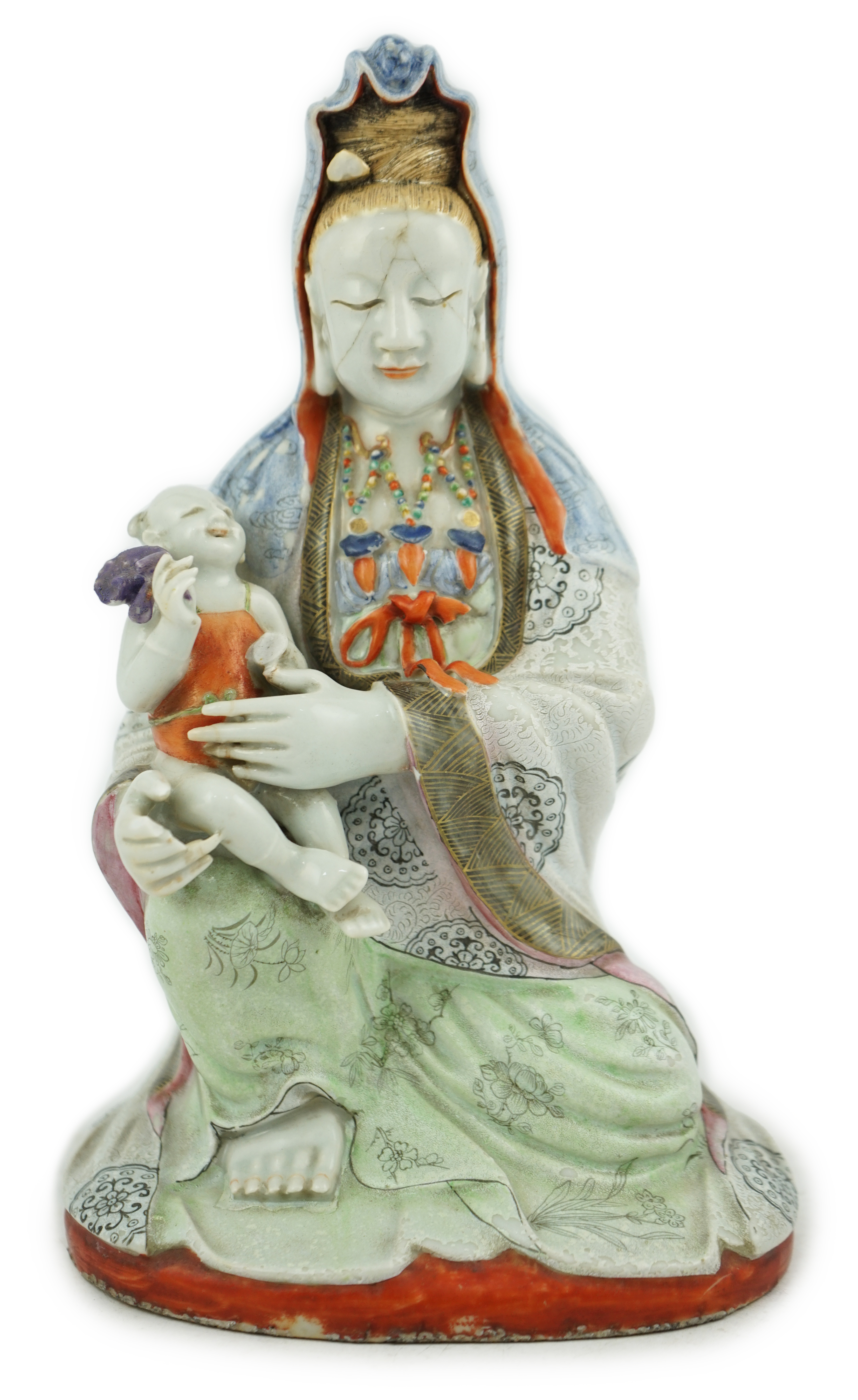 A Chinese enamelled porcelain group of Guanyin holding a child, Qianlong period